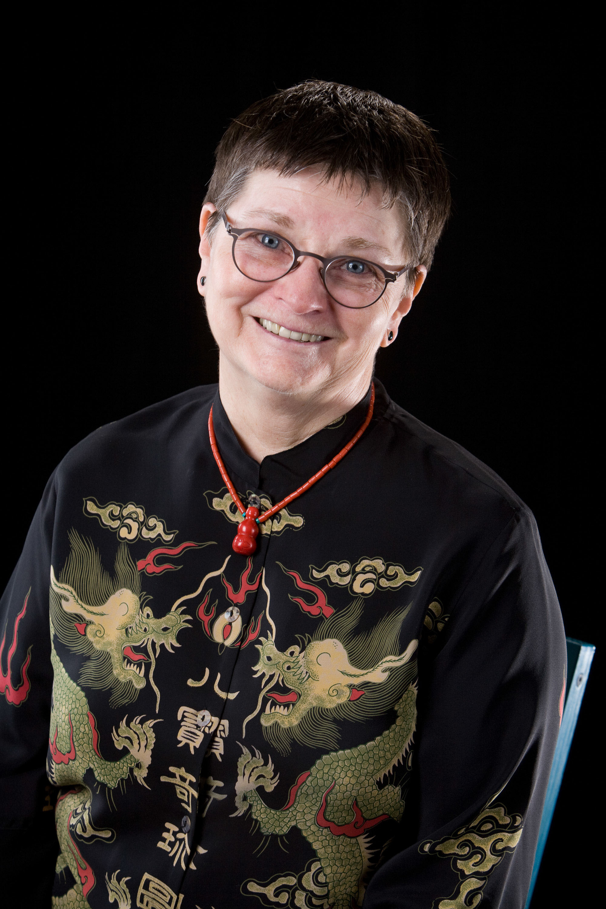 A crisp black-on-black studio portrait