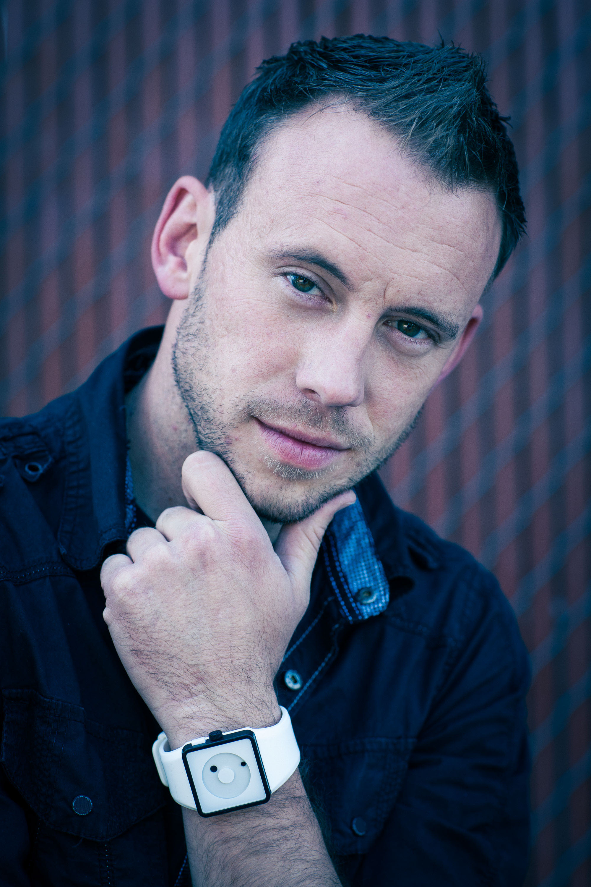 Close up portrait of a young photographer in modern blue tones 