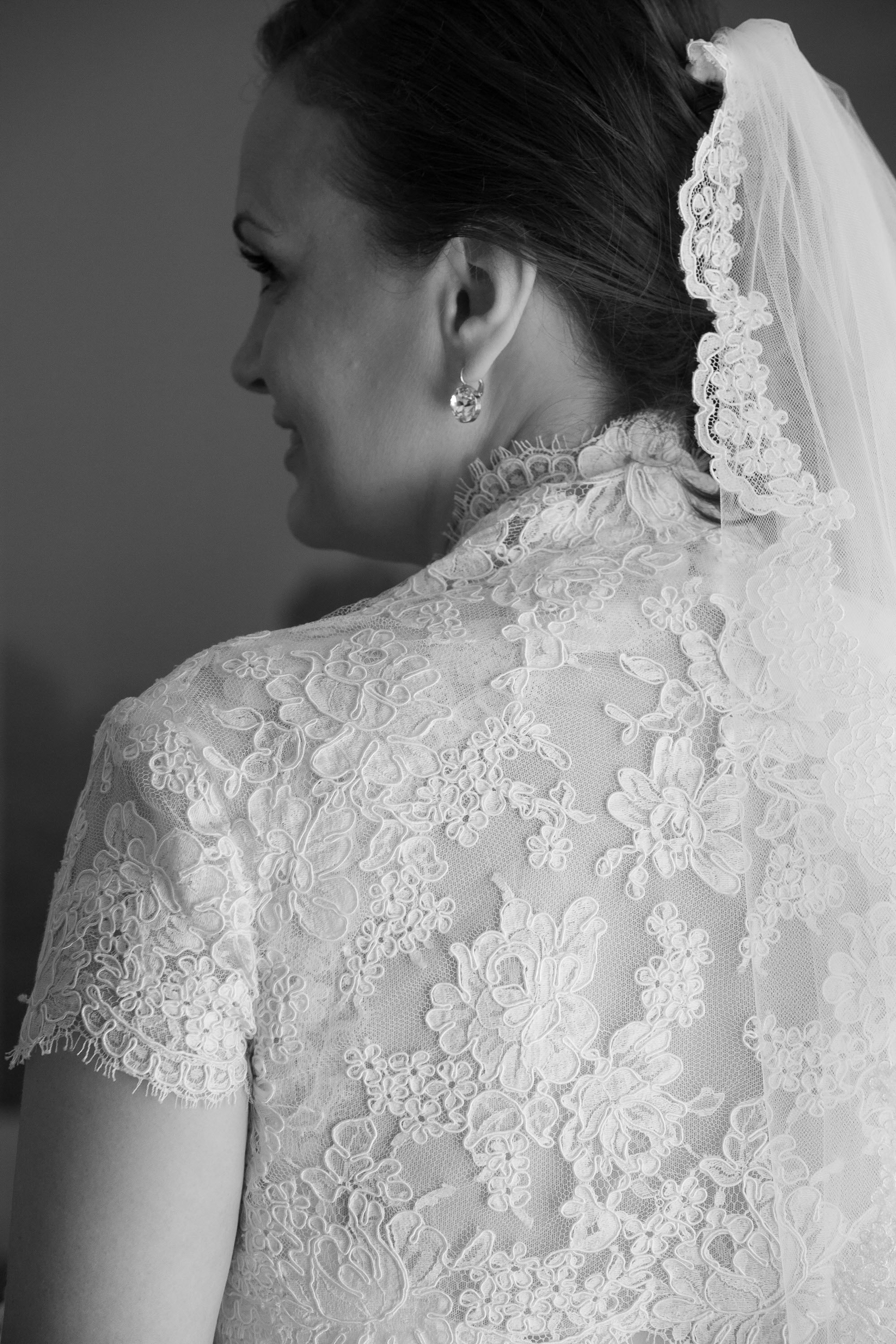 A beautiful window-lit detail of the lace on the bride's dress at the Garden Court Hotel in Palo Alto