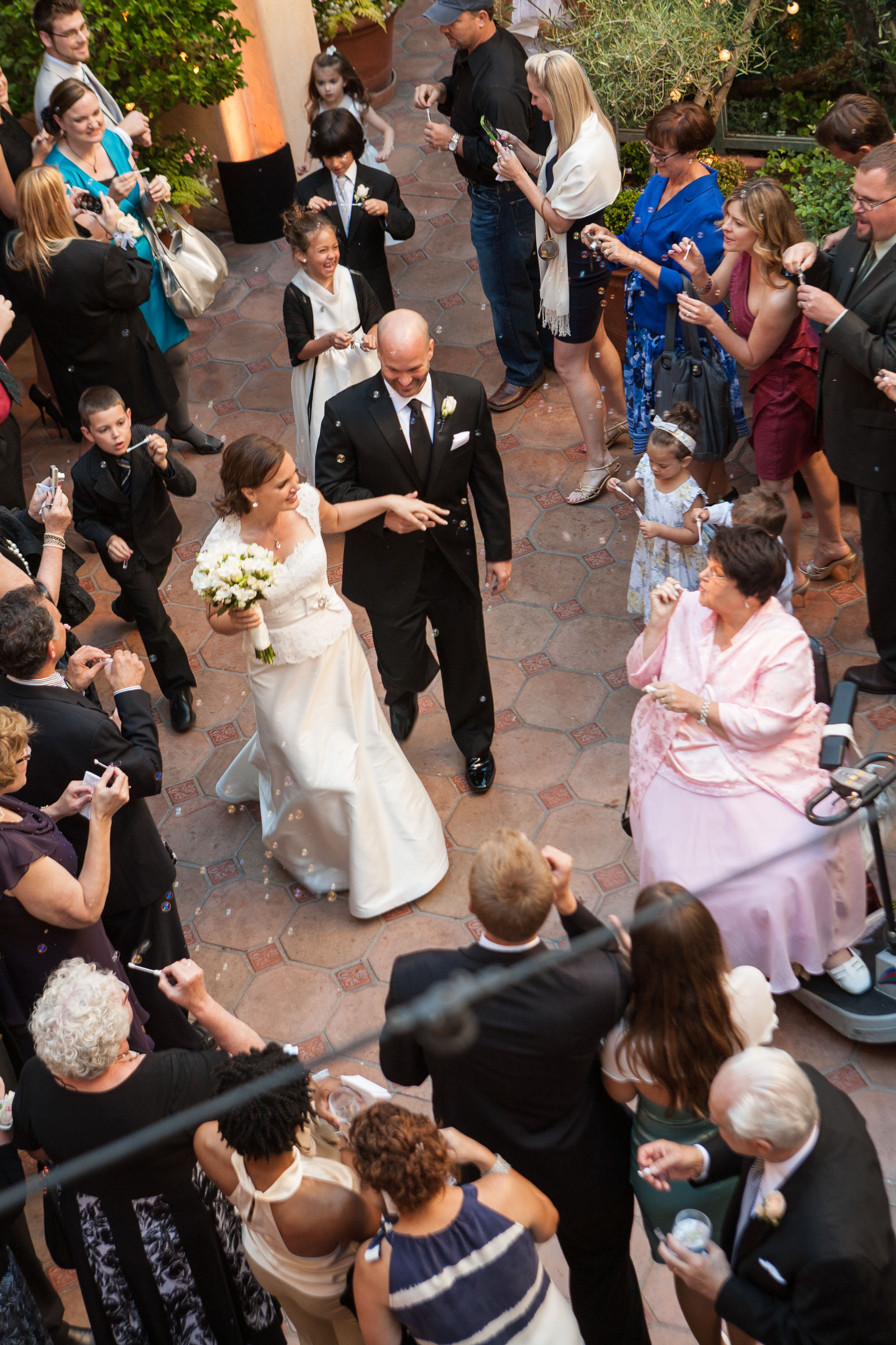 Bride and groom are showered with bubbles as they make their entrance at the Garden Court Hotel in Palo Alto