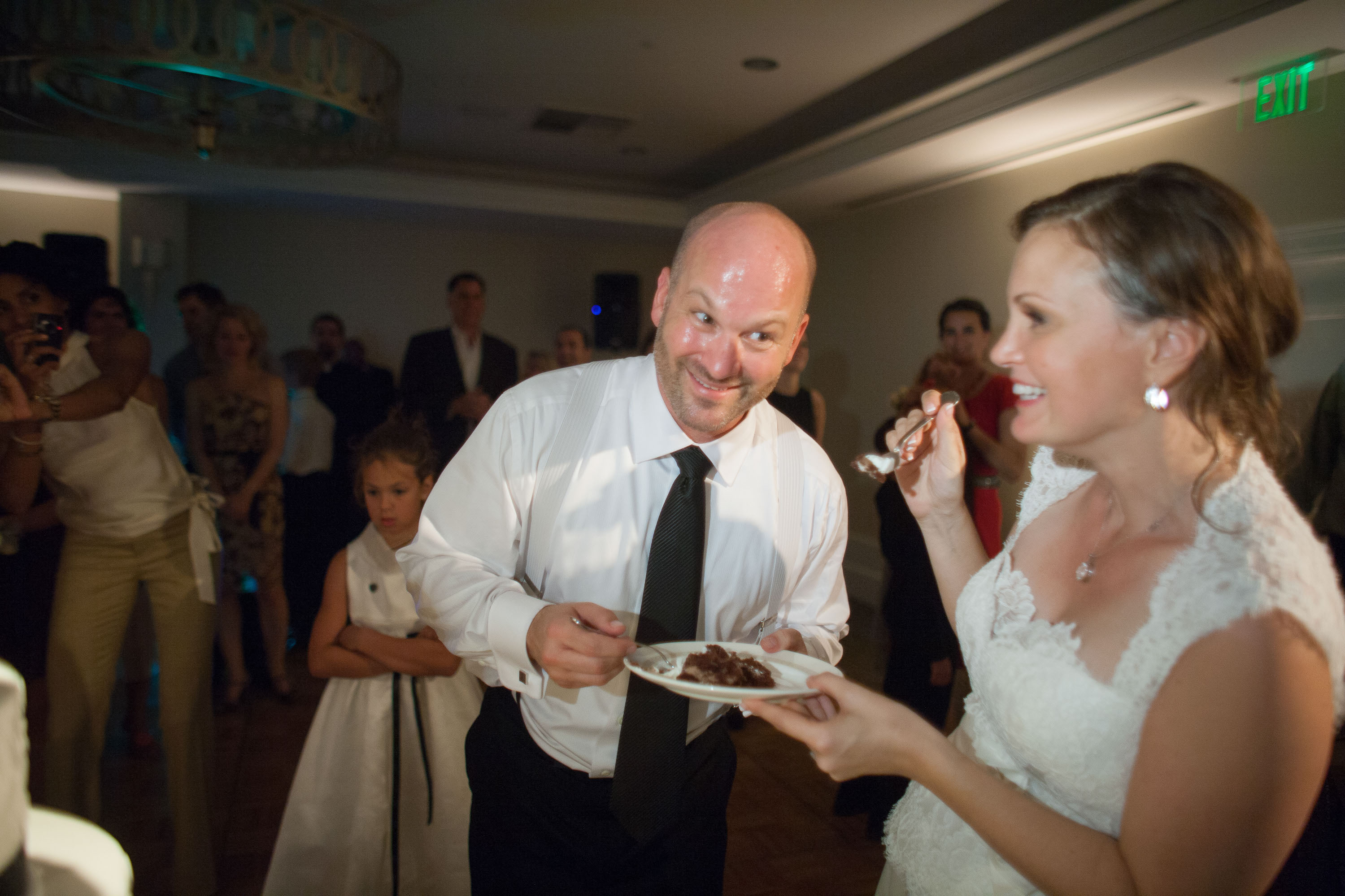 The bride and groom share their first bite of cake at the Garden Court Hotel in Palo Alto