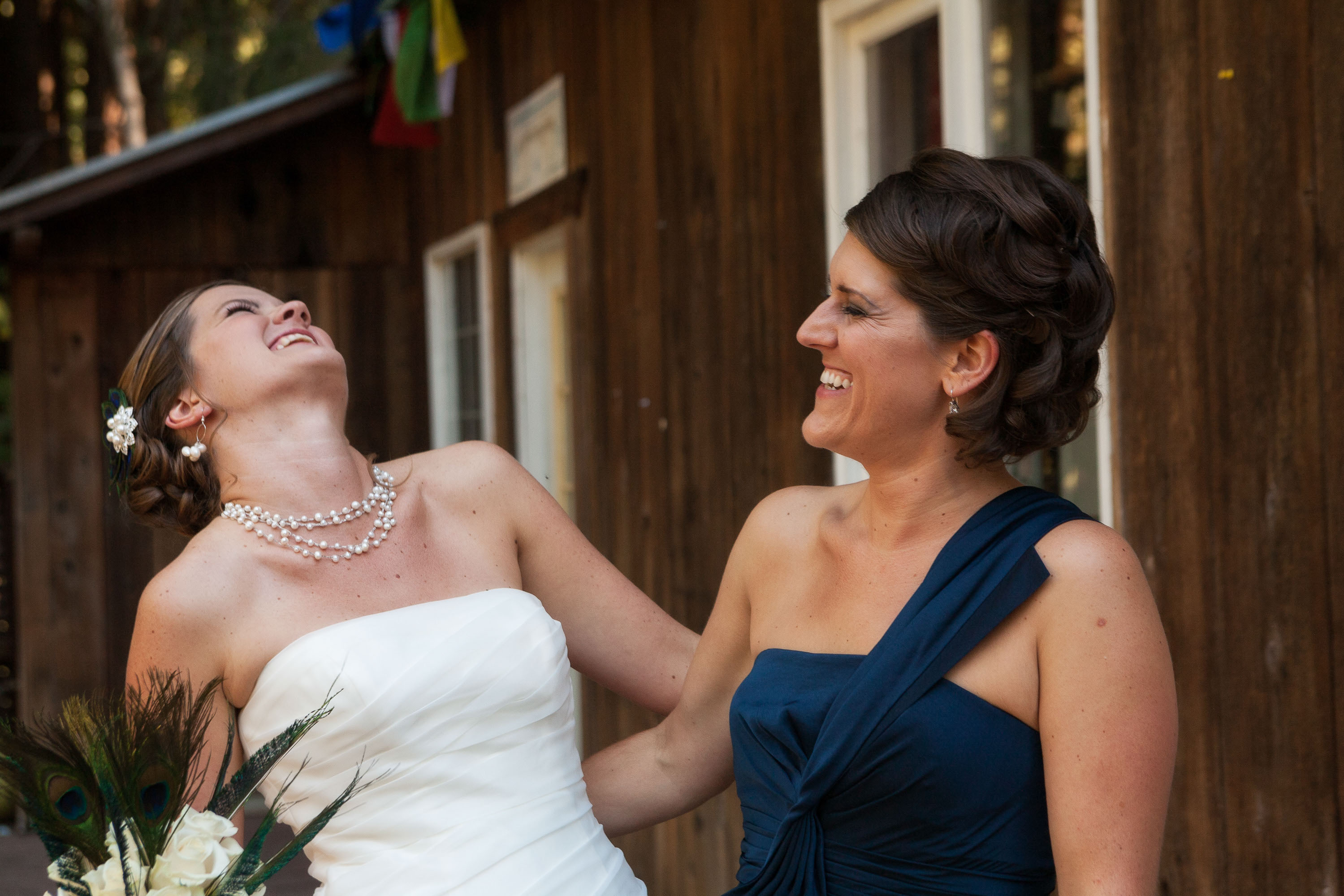 The bride and her sister laugh as they get ready for the ceremony at Pema Osel Ling in the Santa Cruz mountains