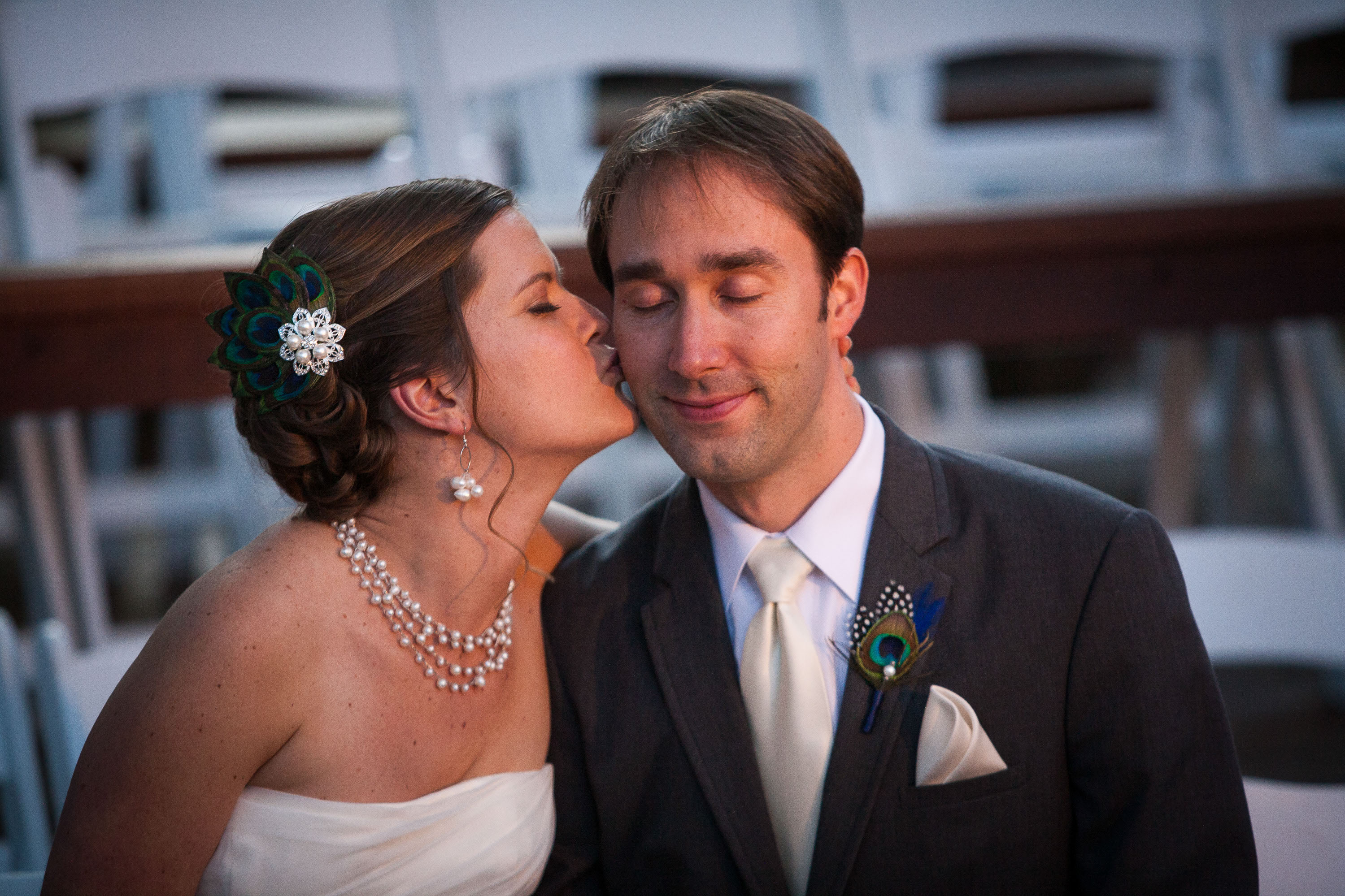 The bride gives a kiss to a happily musing groom at Pema Osel Ling in the Santa Cruz mountains