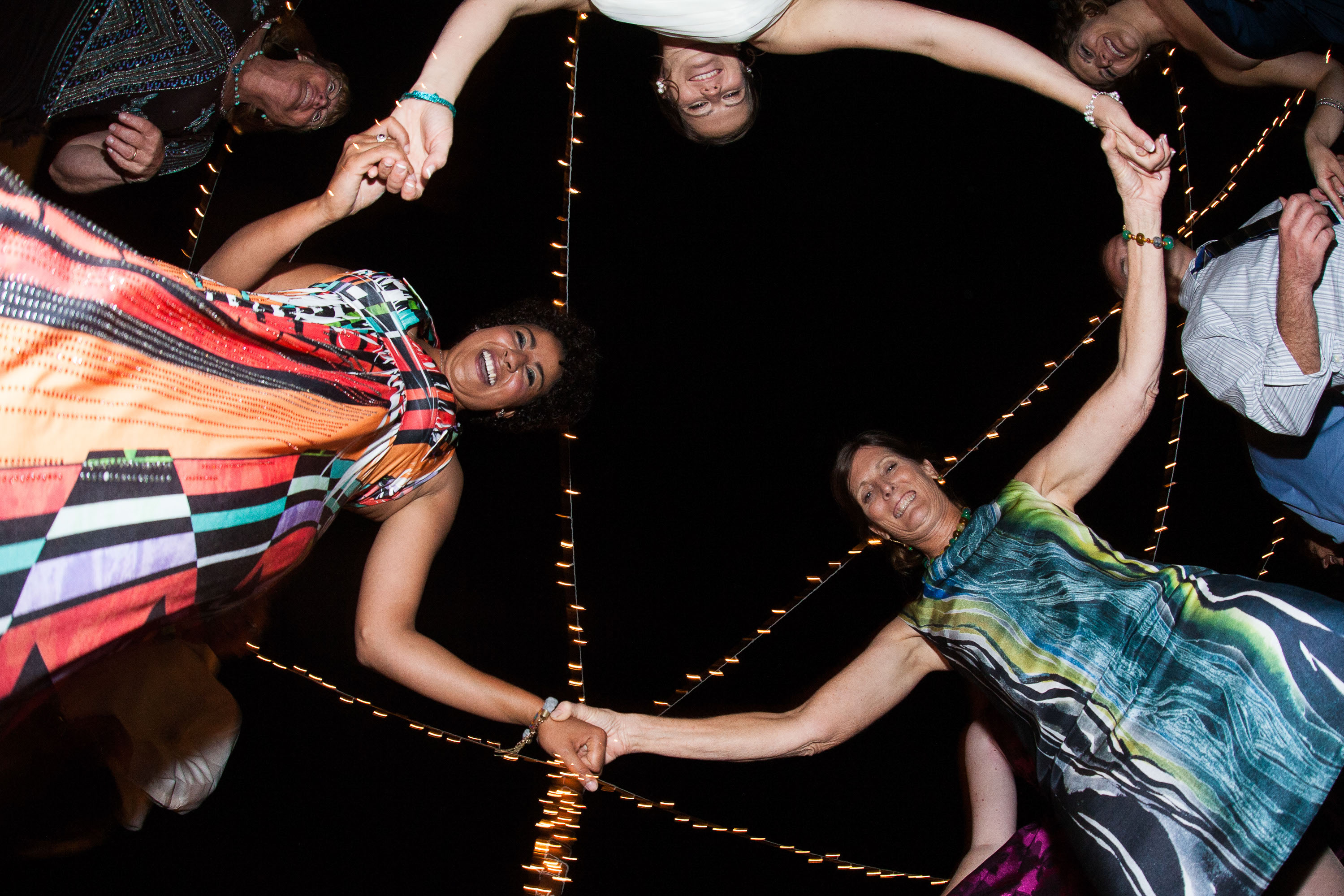 A bugs-eye view of the bride dancing with her mom and sister