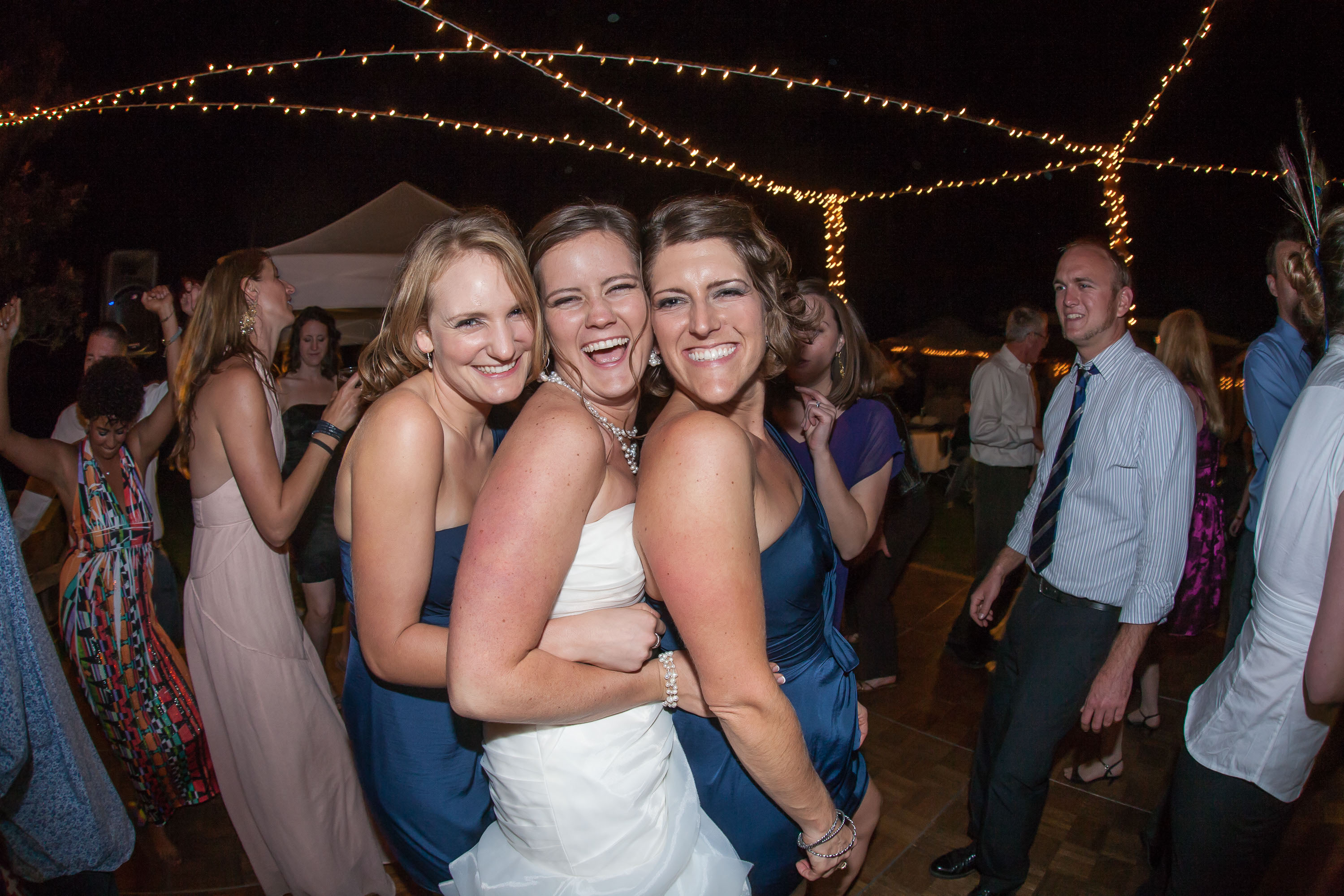 A bride and her girls squeeze close on the dance floor at Pema Osel Ling in the Santa Cruz mountains
