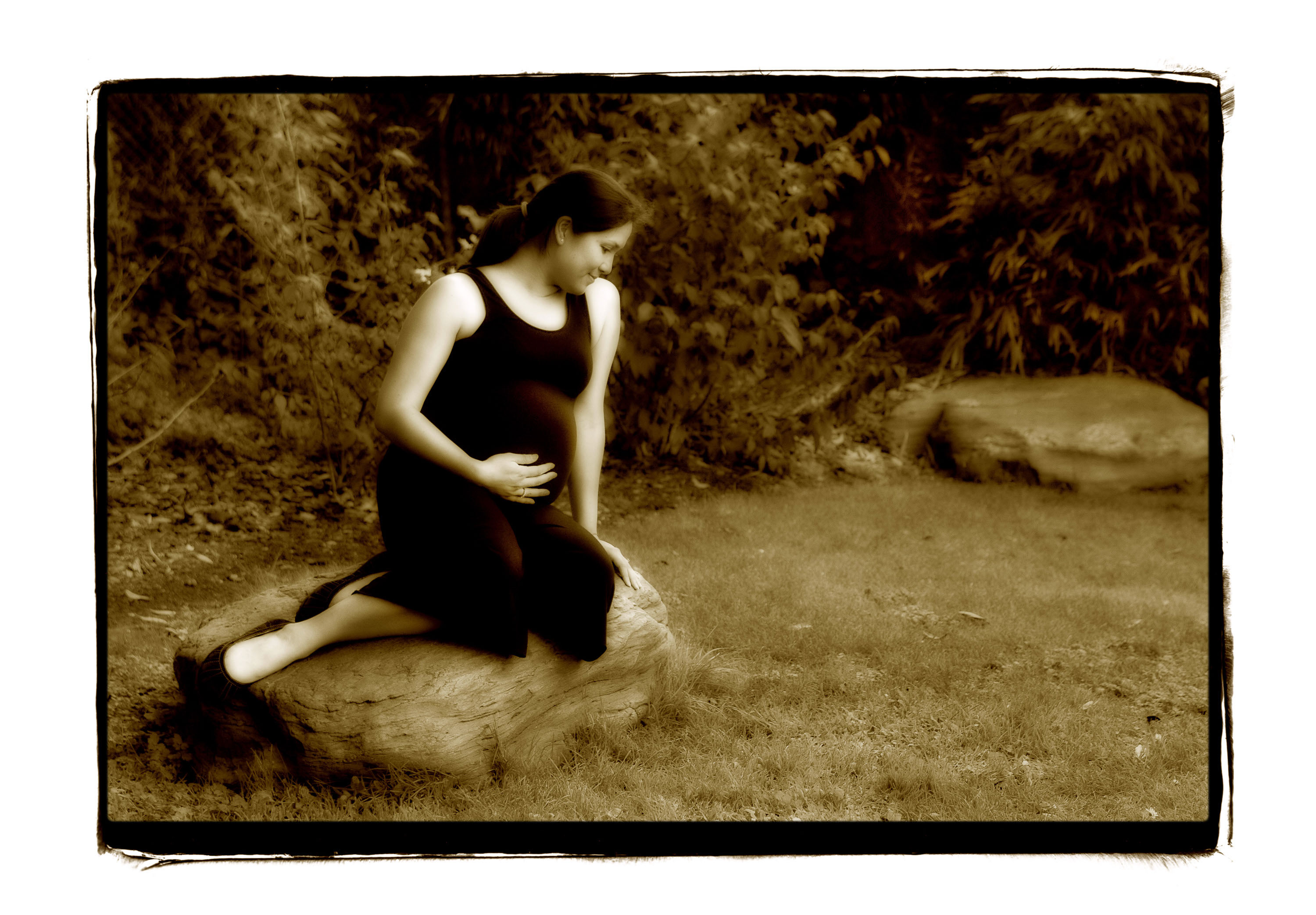A classic maternity portrait made in Golden Gate Park, rendered in deep sepia tones.