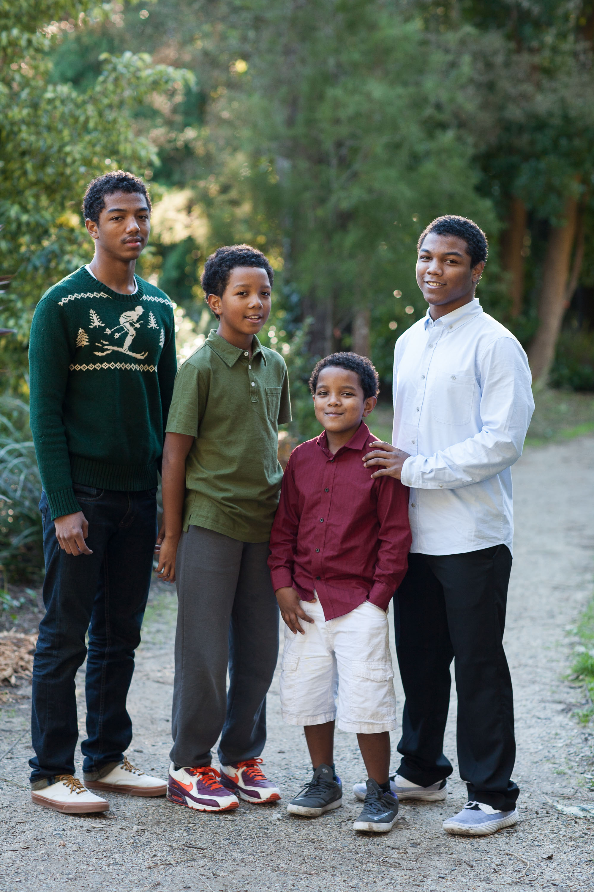 Four African American brothers pose together in the beautiful light of the San Francisco Botanical Garden.