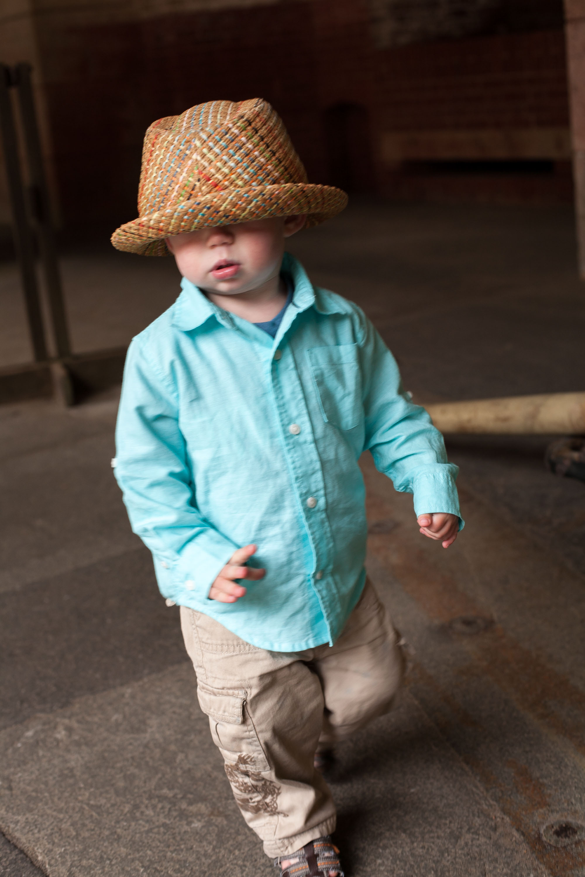 Adorable portrait of a little boy wearing his dad's fedora at Fort Point.