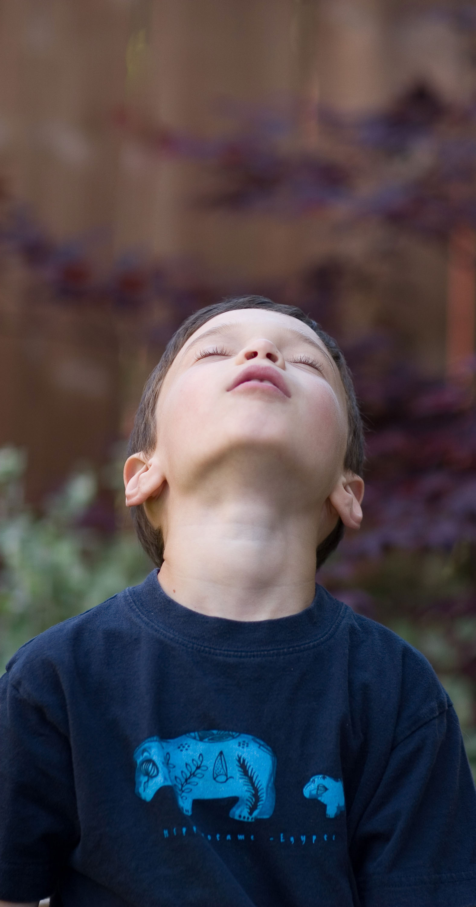 A young man dreams skyward in a candid portrait by Checkerbox Photography