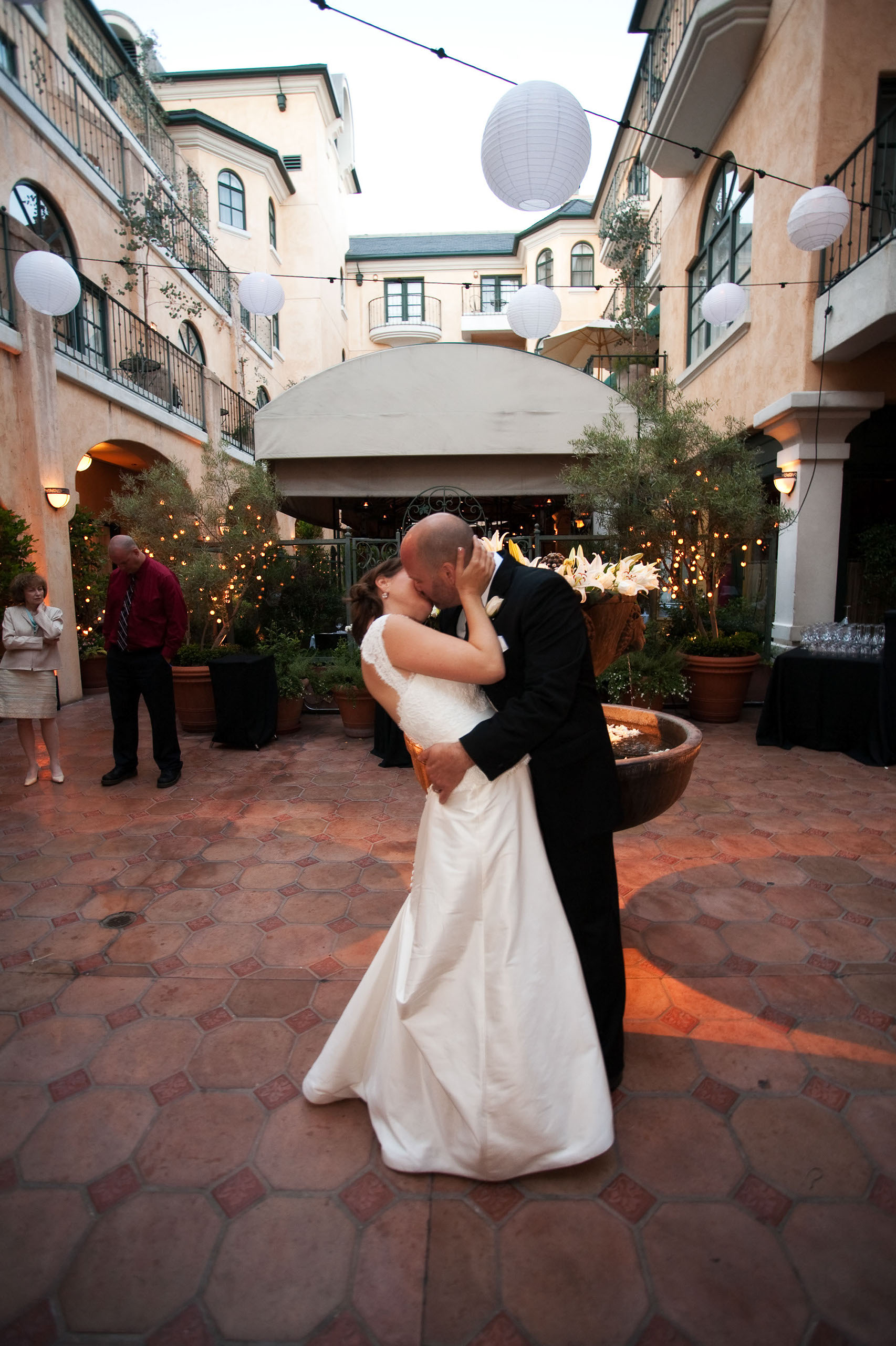 A couple steals a kiss on their wedding day at the Garden Court Hotel in Palo Alto