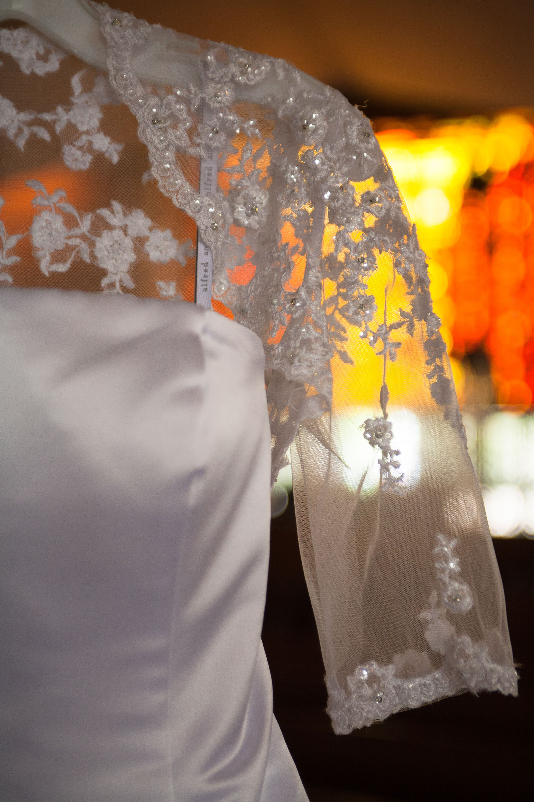 A closeup of an Alfred Angelo wedding gown lace shoulder jacket at St. Mary's Cathedral in San Francisco