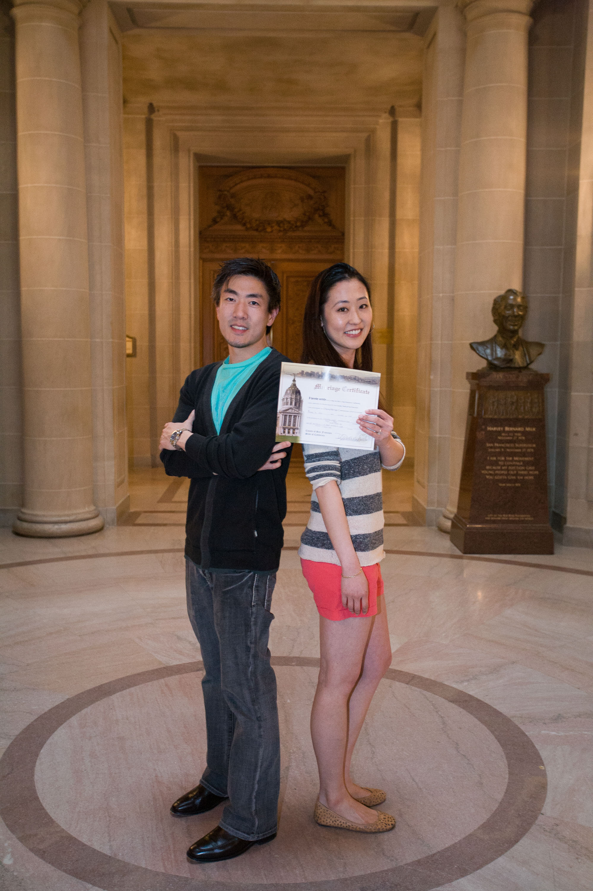 Just married! A couple shows off their wedding license at a San Francisco City Hall wedding