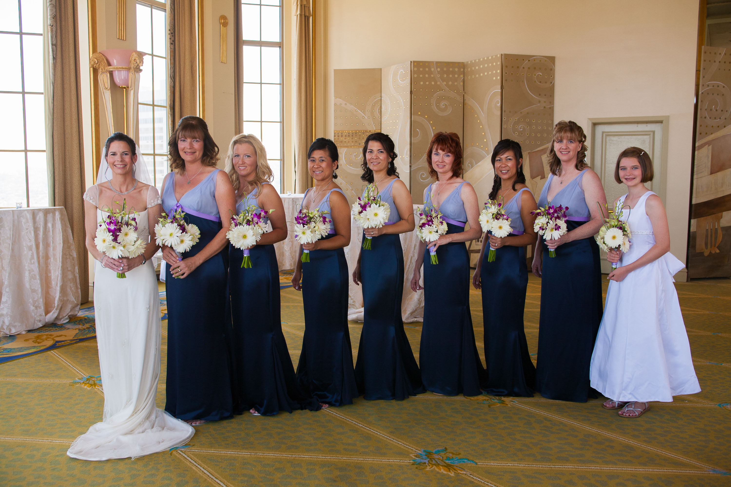 An elegant row of bridesmaids in Victor's Palace  at the St. Francis Hotel in San Francisco