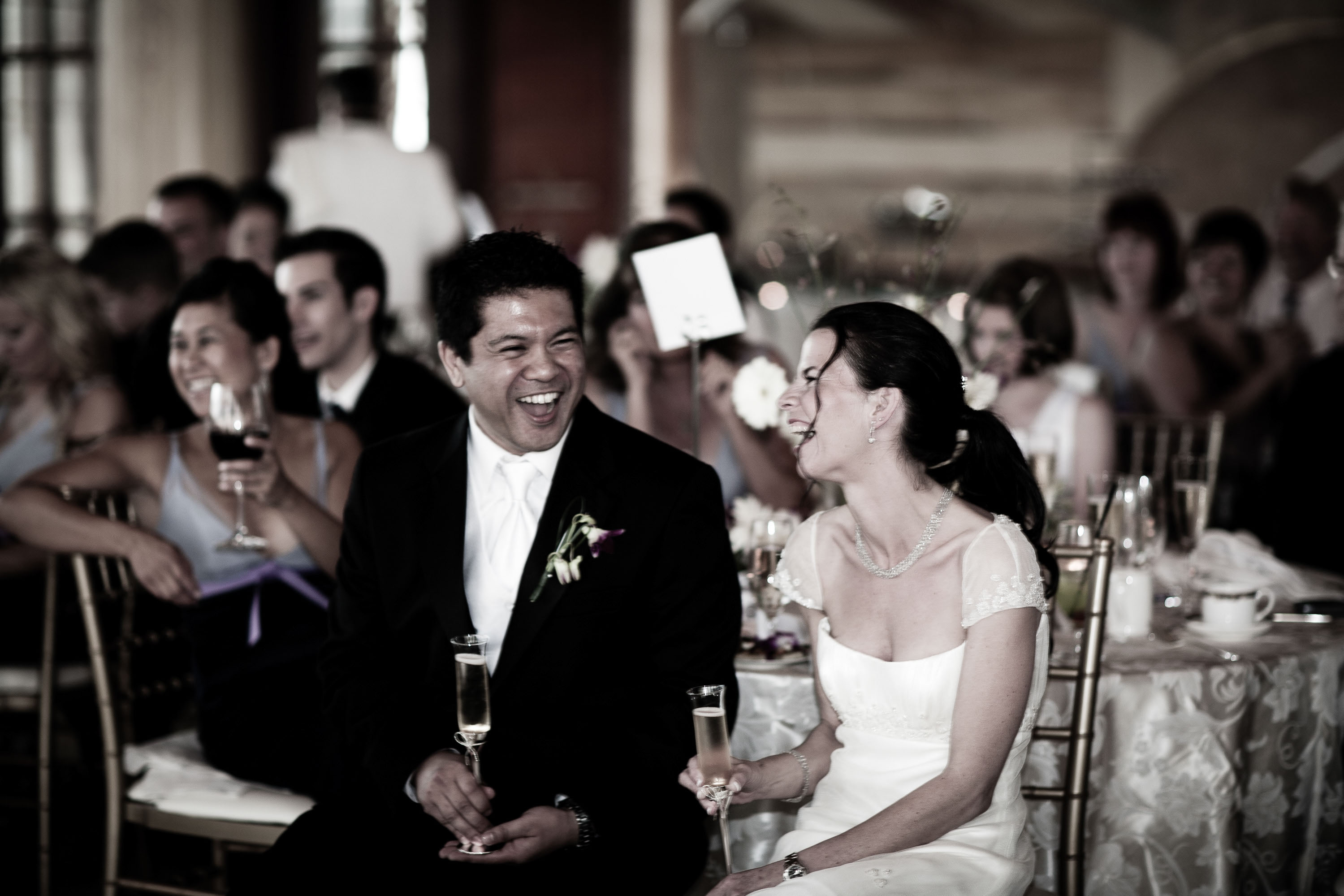The bride and groom laugh during toasts  at the St. Francis Hotel in San Francisco