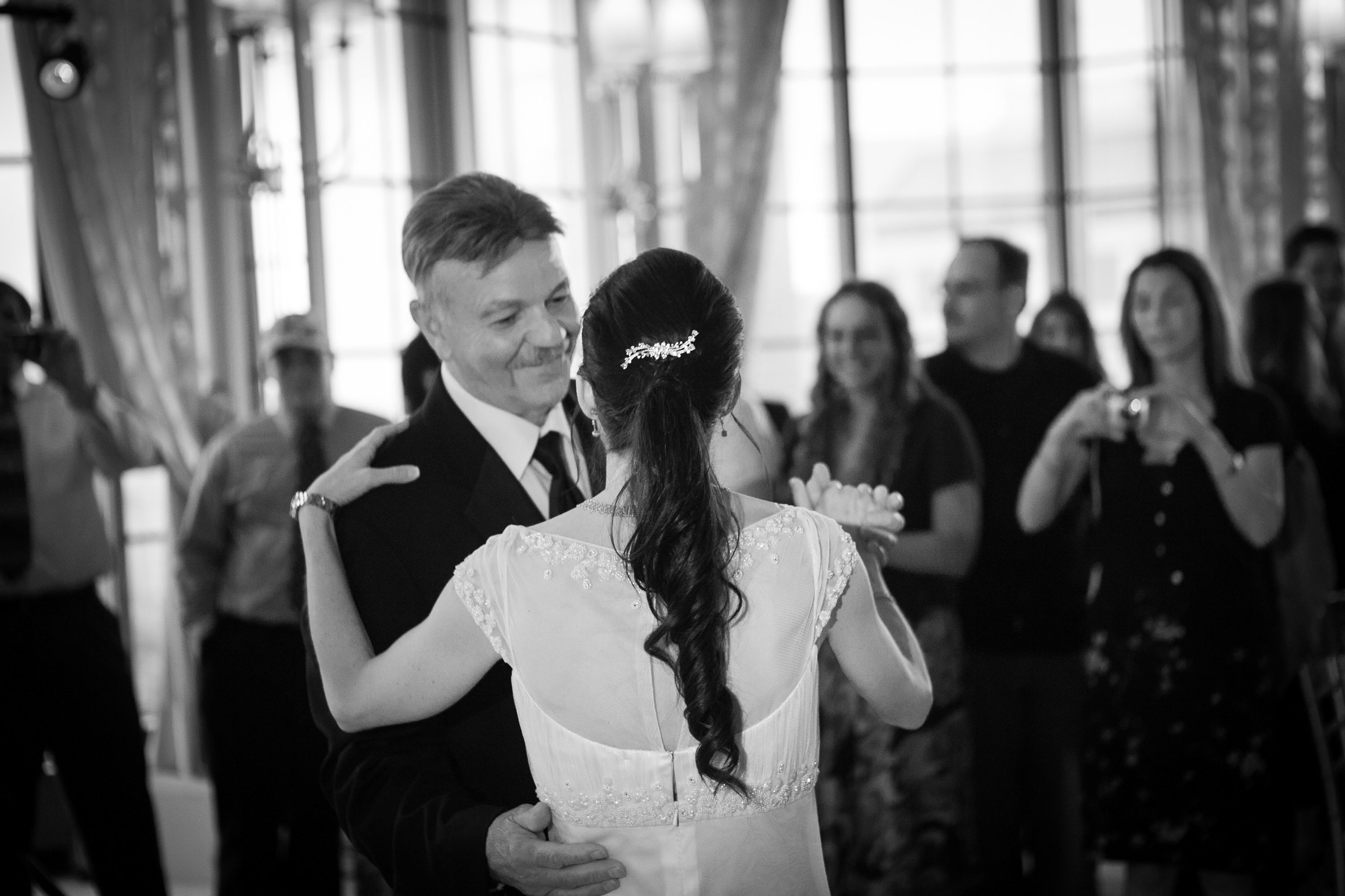 A smiling dad dances with his daughter on her wedding day,  at the St. Francis Hotel in San Francisco