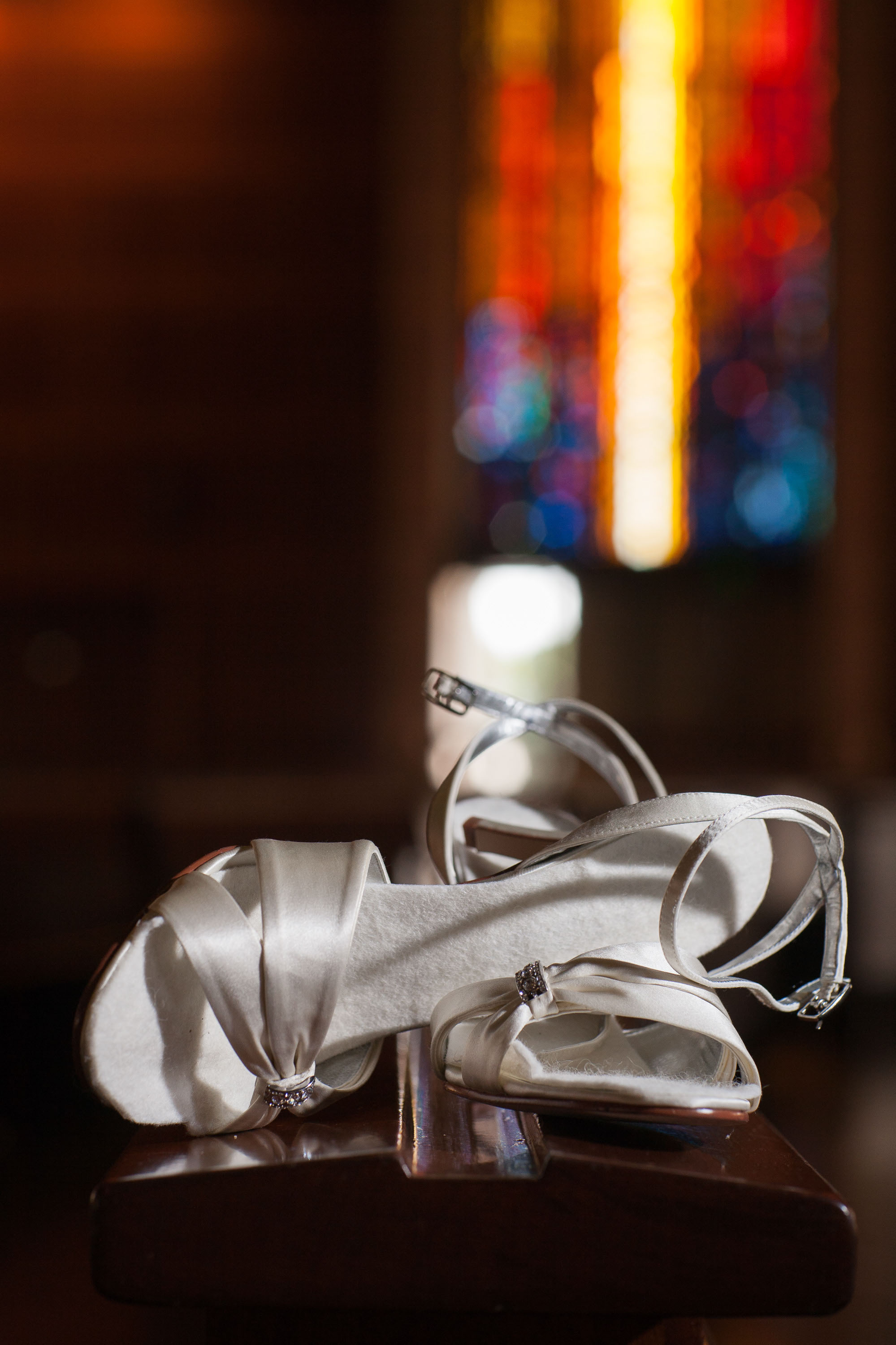 The stained glass of St. Mary's Cathedral in San Francisco makes a stunning backdrop for the bride's white heels.