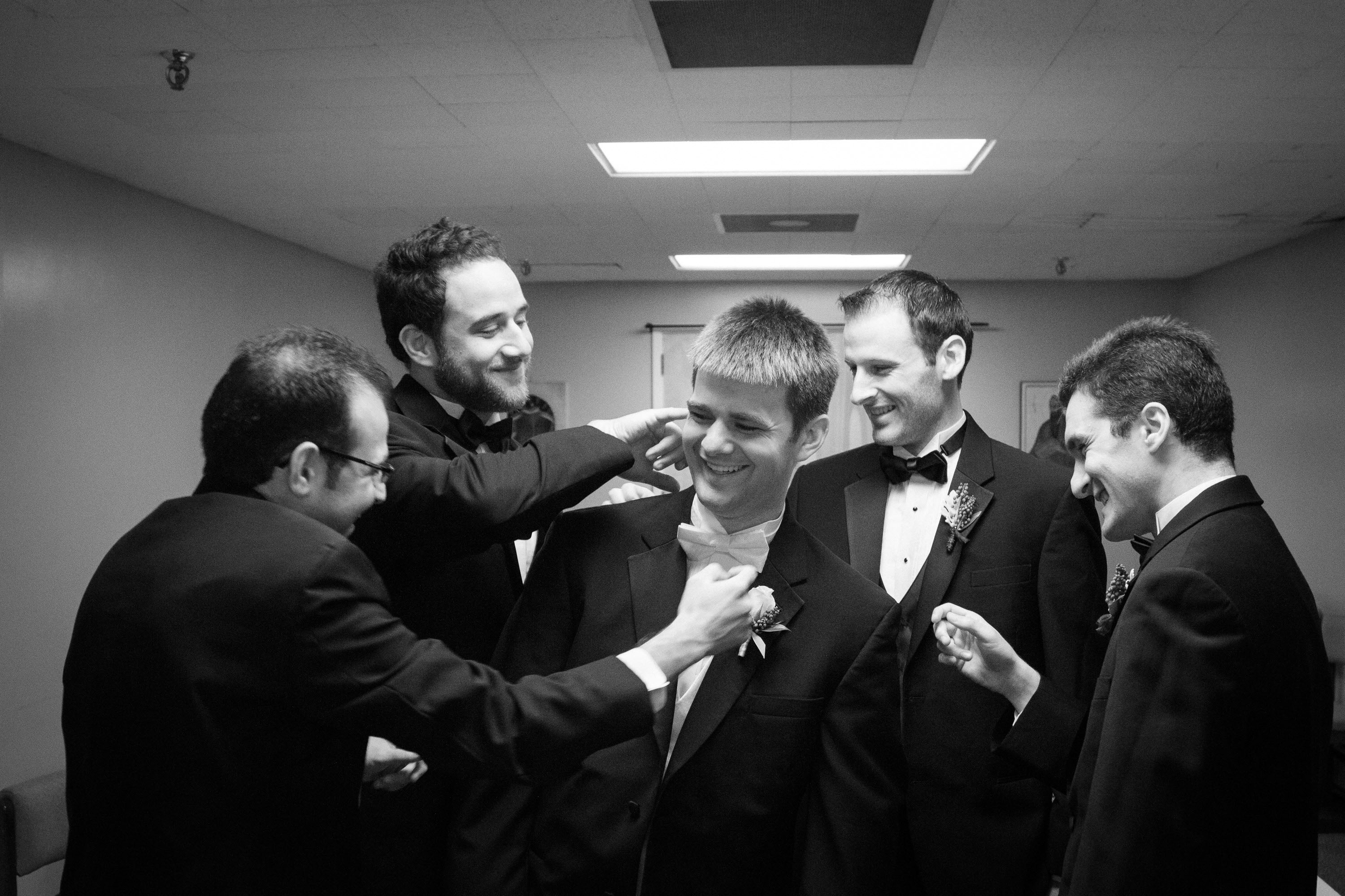 The groomsmen perform final adjustments for the groom,   at St. Mary's Cathedral in San Francisco.