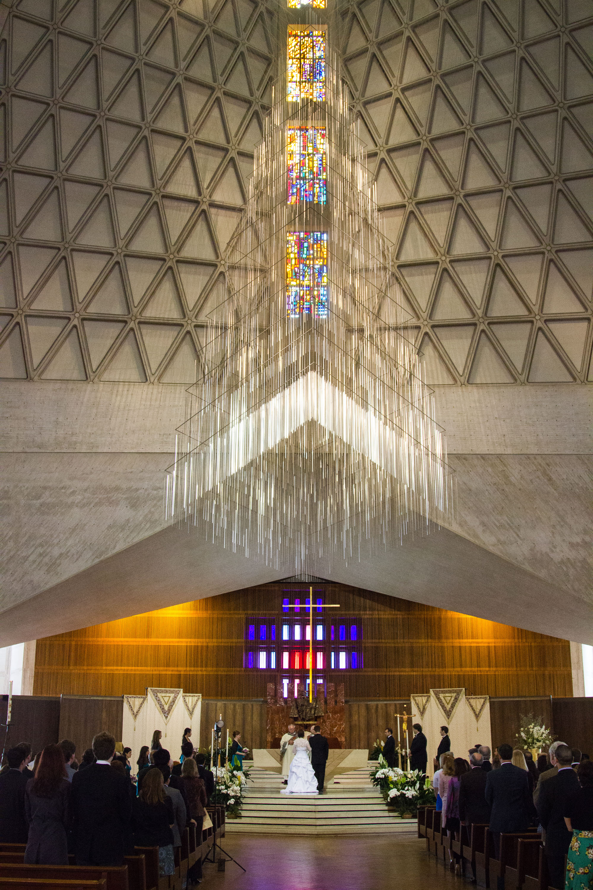 A couple is married beneath the Richard Lippold sculpture  at St. Mary's Cathedral in San Francisco.
